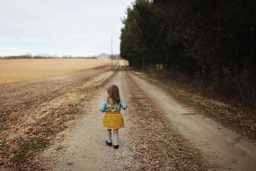 ילדה עם חצאית הולכת בשדה